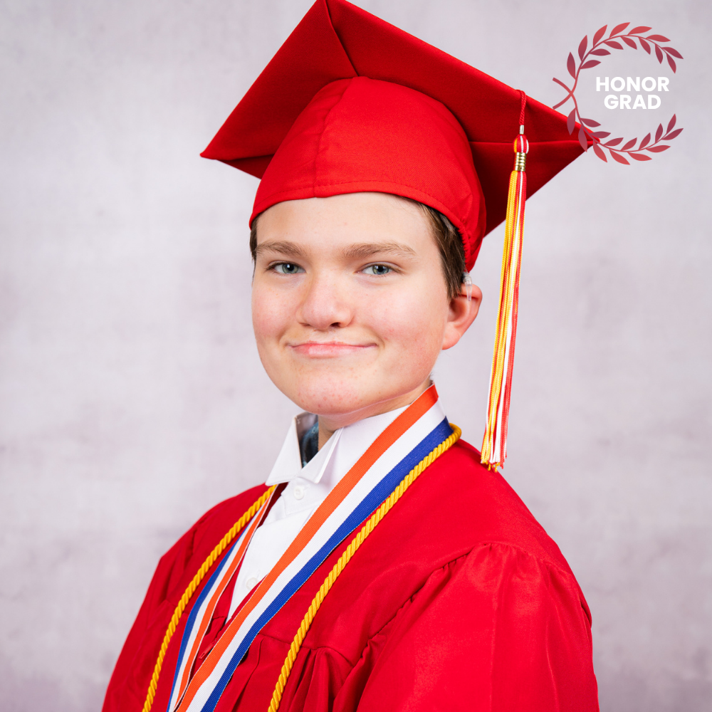 Gavin Swart wearing a red cap and gown.