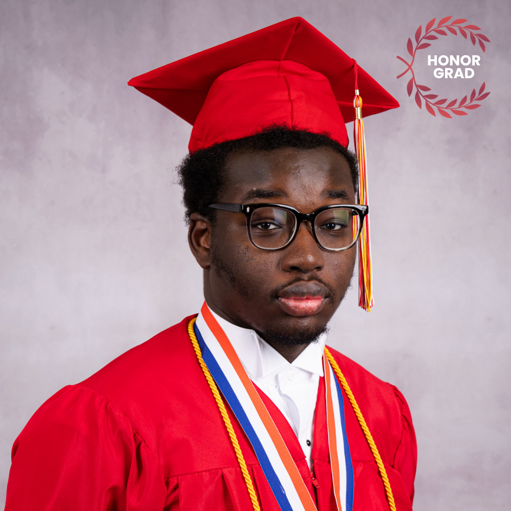 Muntaser Wadi wearing a red cap and gown.
