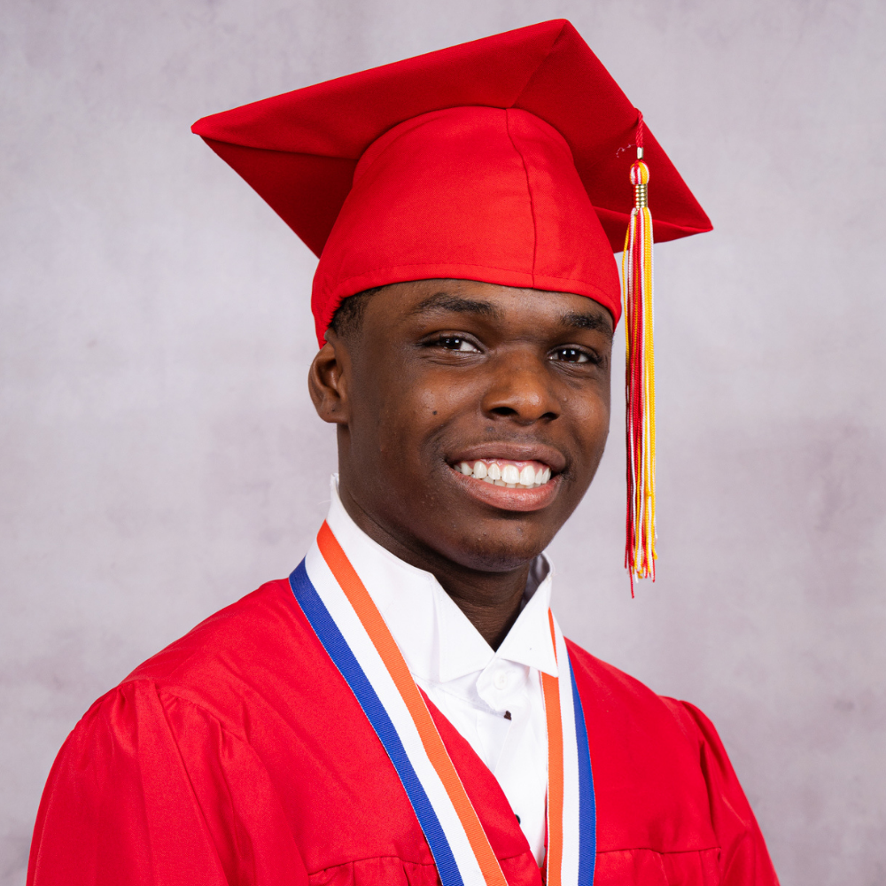 Semaj Wright wearing a red cap and gown.