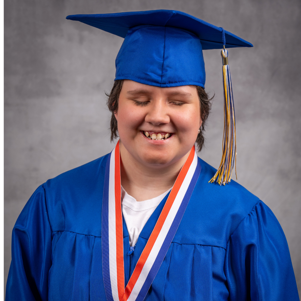Janna Clark wearing a blue cap and gown.