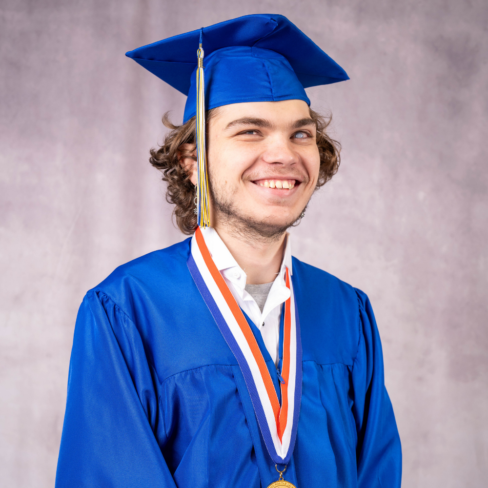 Caidan Hadley wearing a blue cap and gown.