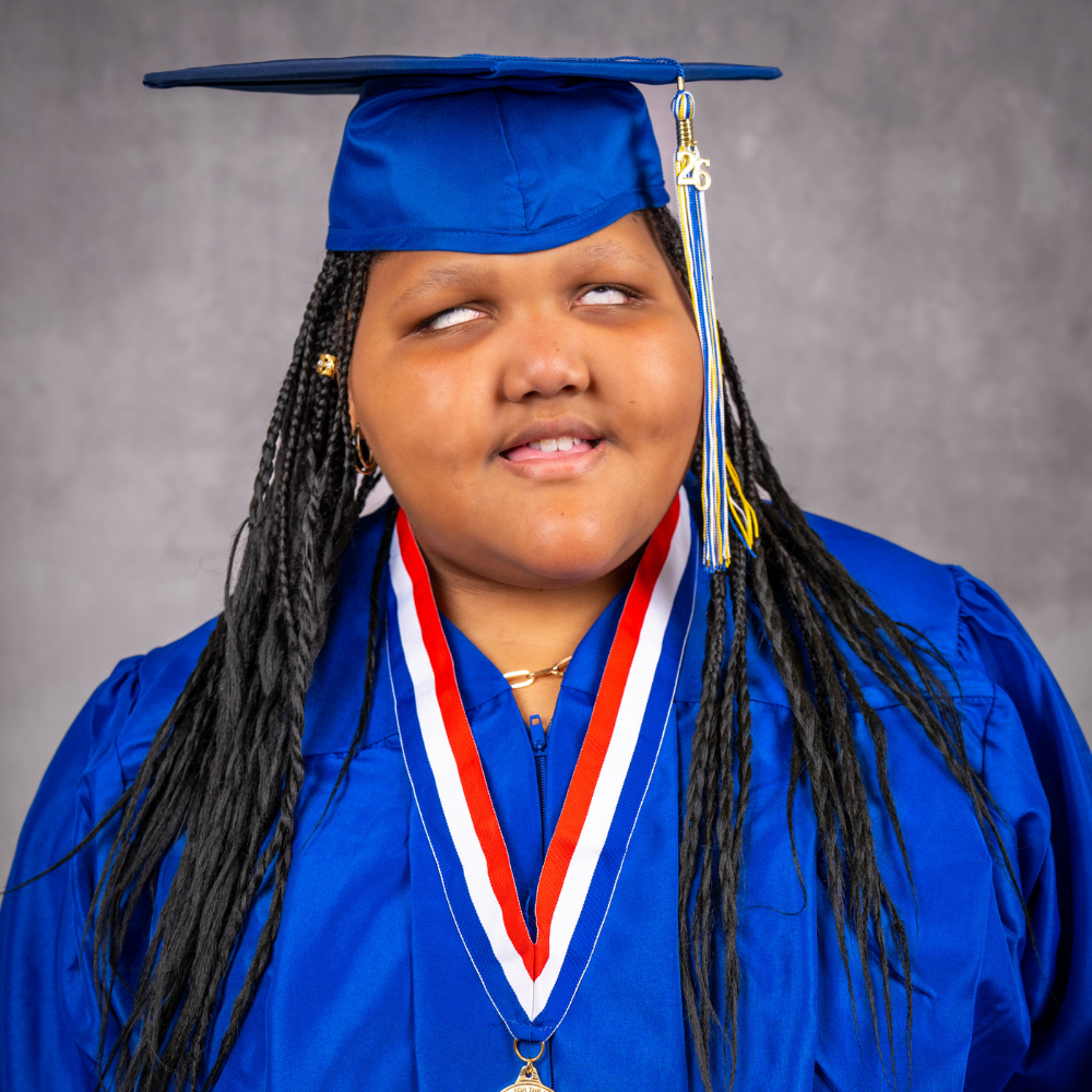 Isabelle Lacroix wearing a blue cap and gown.