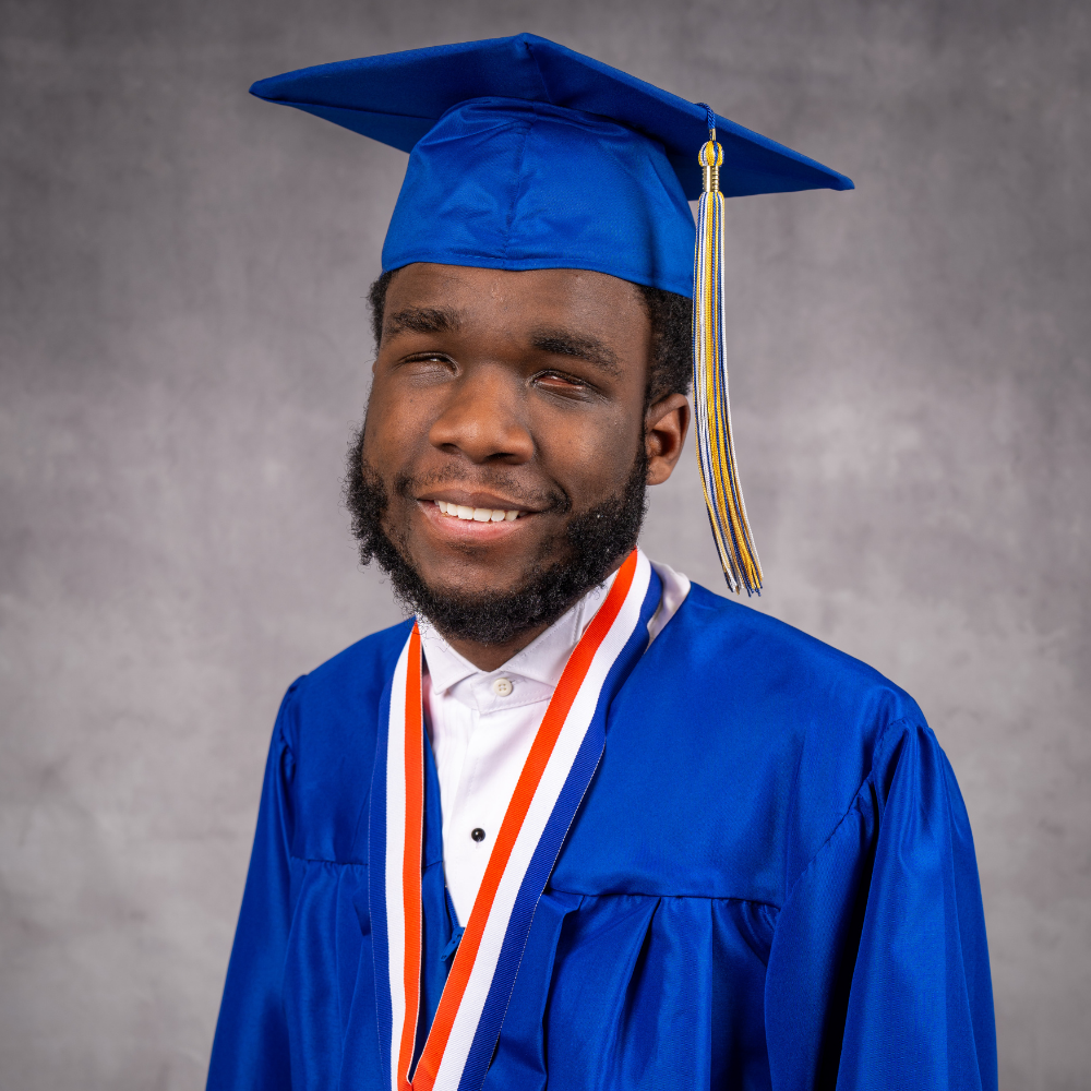Gamari Lewis wearing a blue cap and gown.