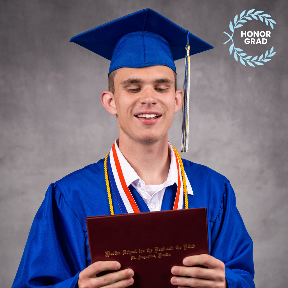 Jasen McDaniel wearing a blue cap and gown.