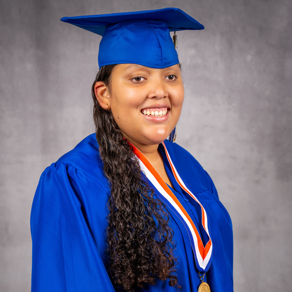 Angelina Solorzano wearing a blue cap and gown.