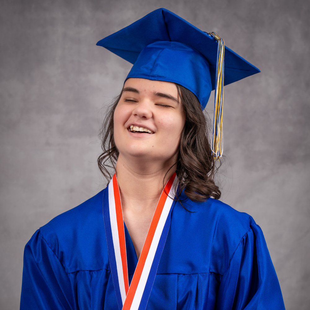 Caitlin White wearing a blue cap and gown.