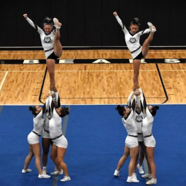 Cheerleaders hold flyers during competition