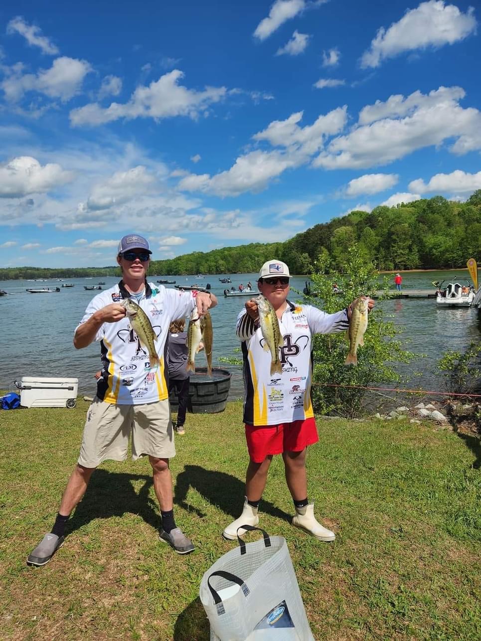 Two people posing with fish