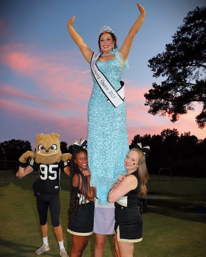 Senior Cheerleading crowned homecoming queen in a stunt