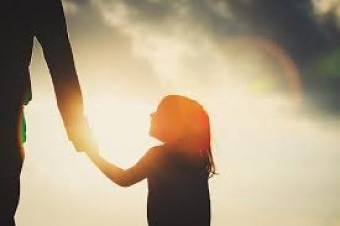 little girl holding her dad hand