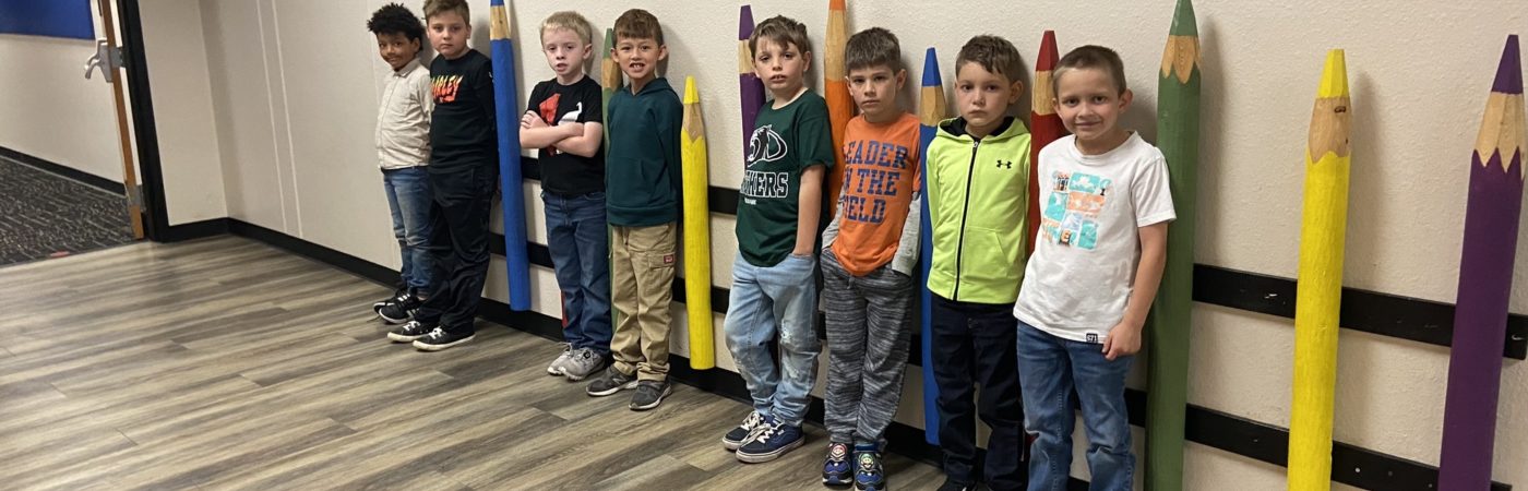 kids standing and laying on the wall 