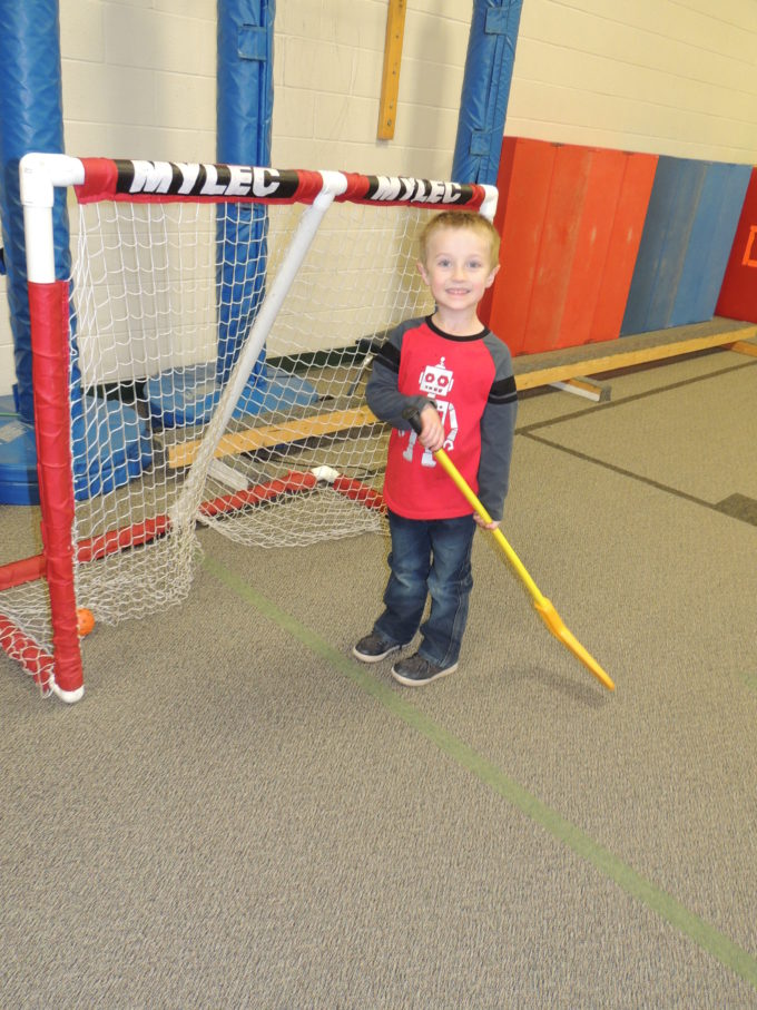student holding a hockey stick