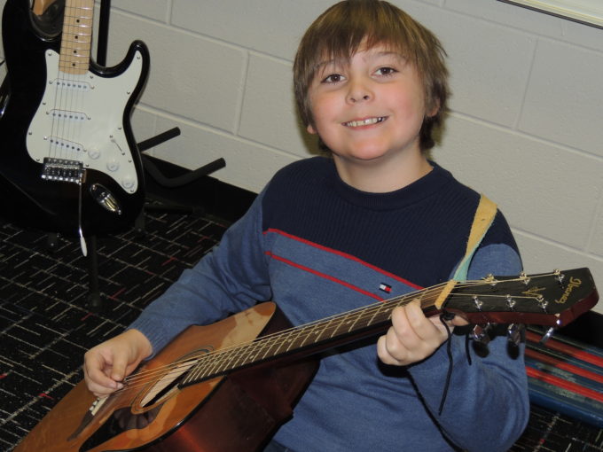 student playing the guitar 