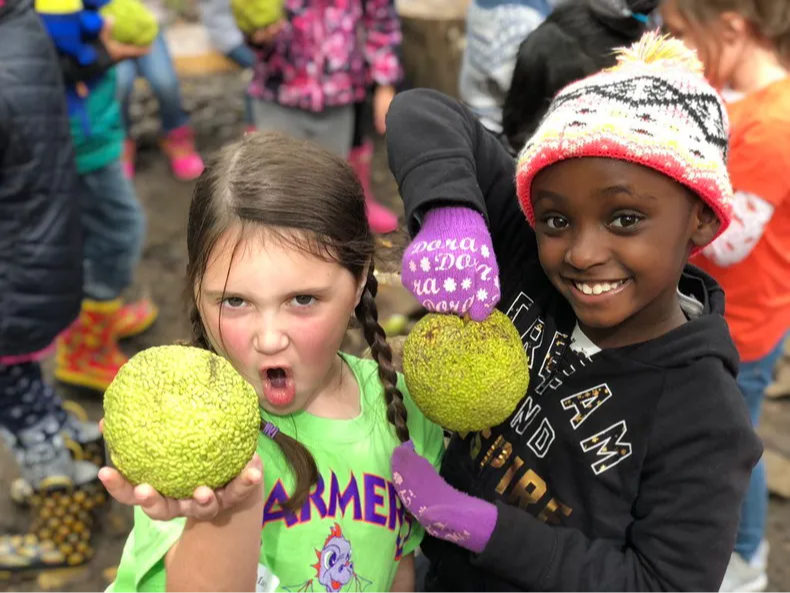 Students holding fruit