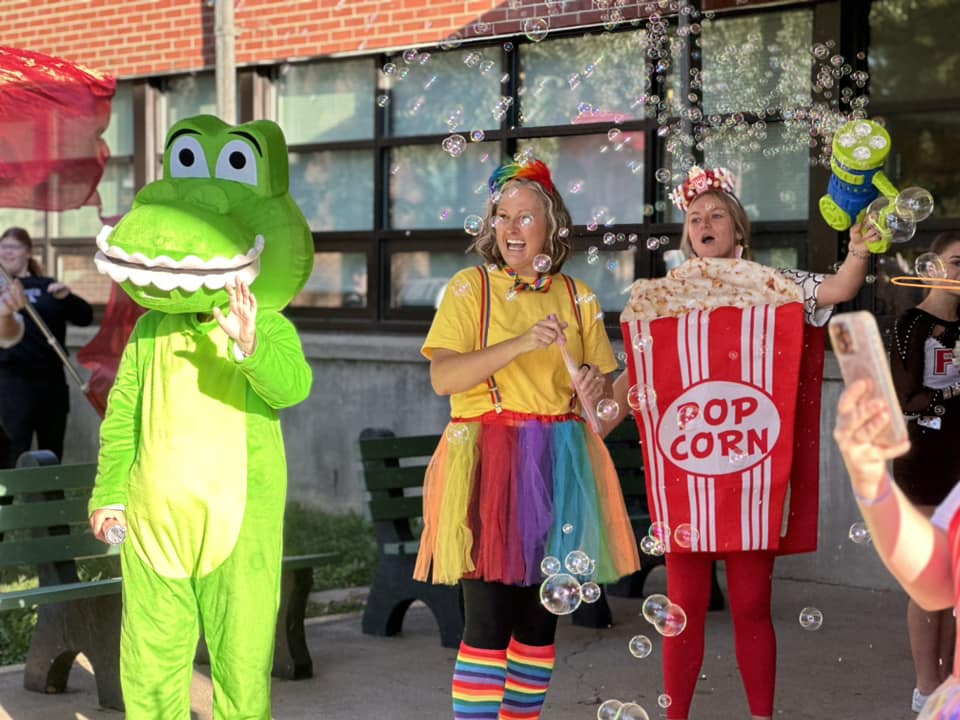 gator mascot and two women in costumes