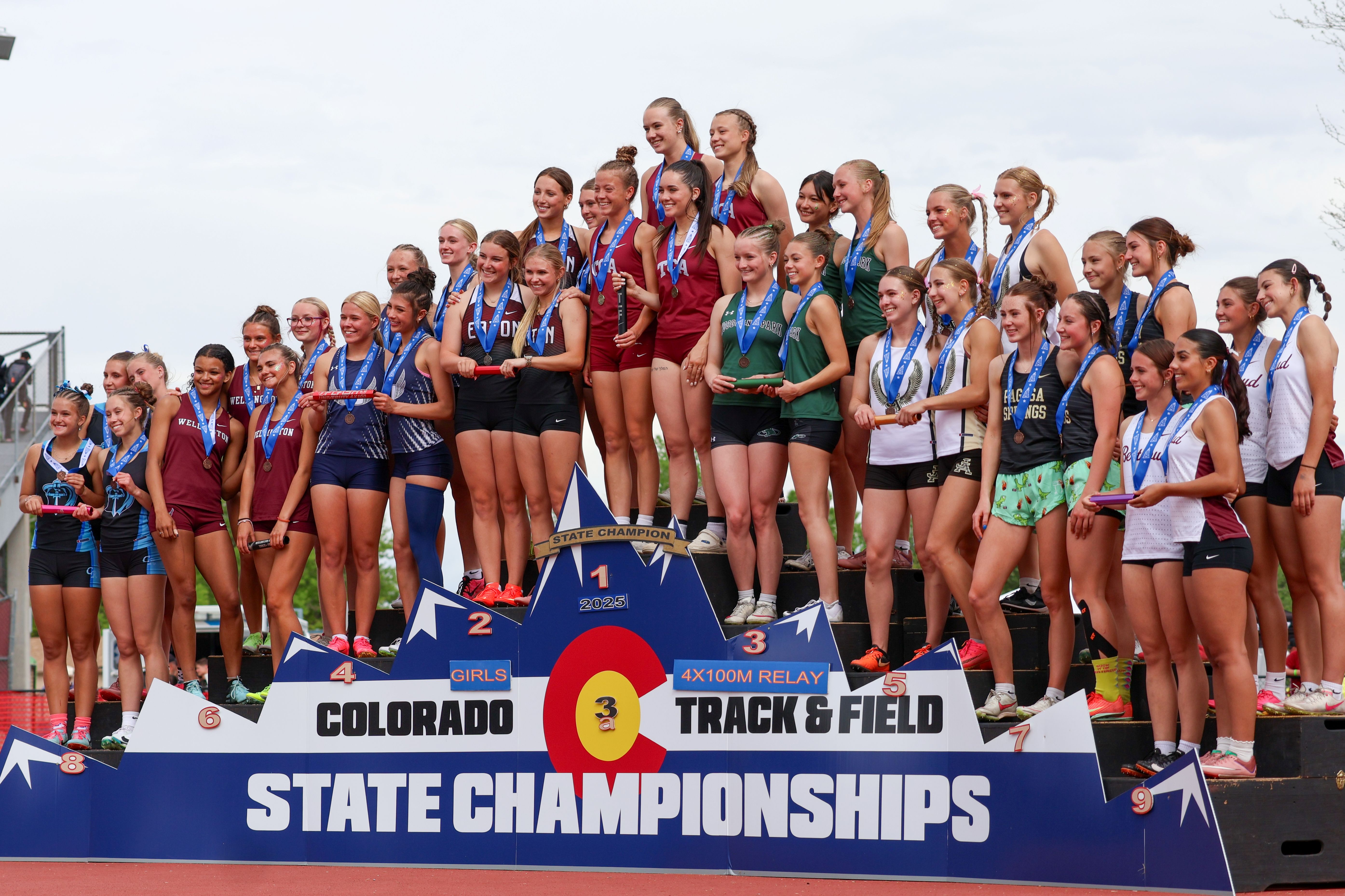 Girls relay team on podium at the 2025 state track meet for their 3rd place finish
