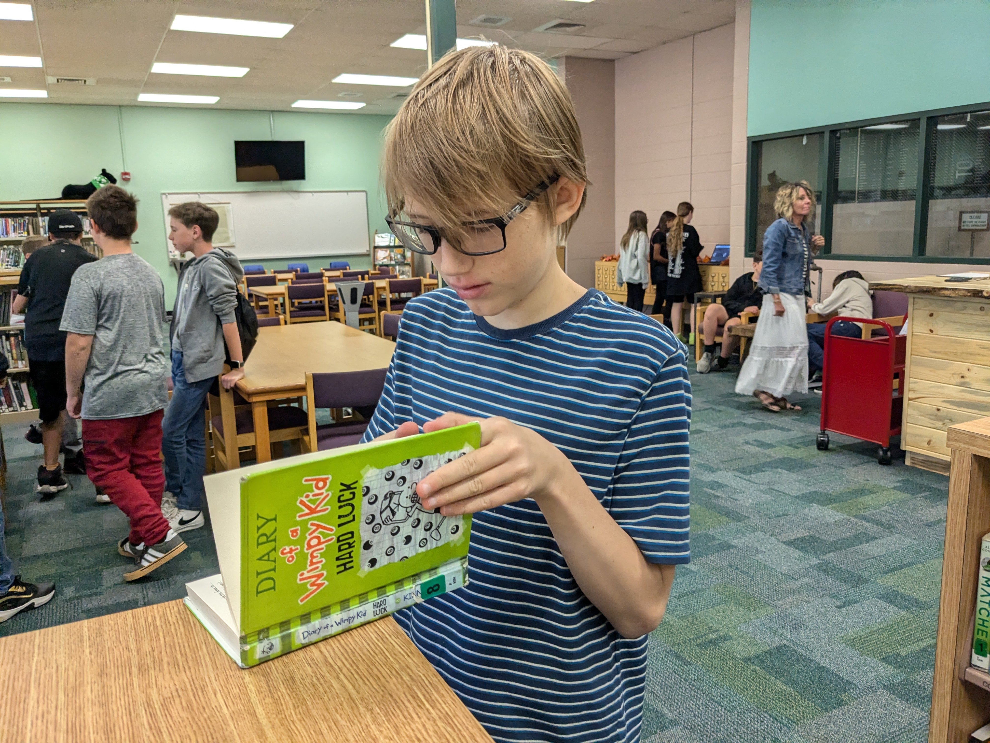 A student looking a book in the library
