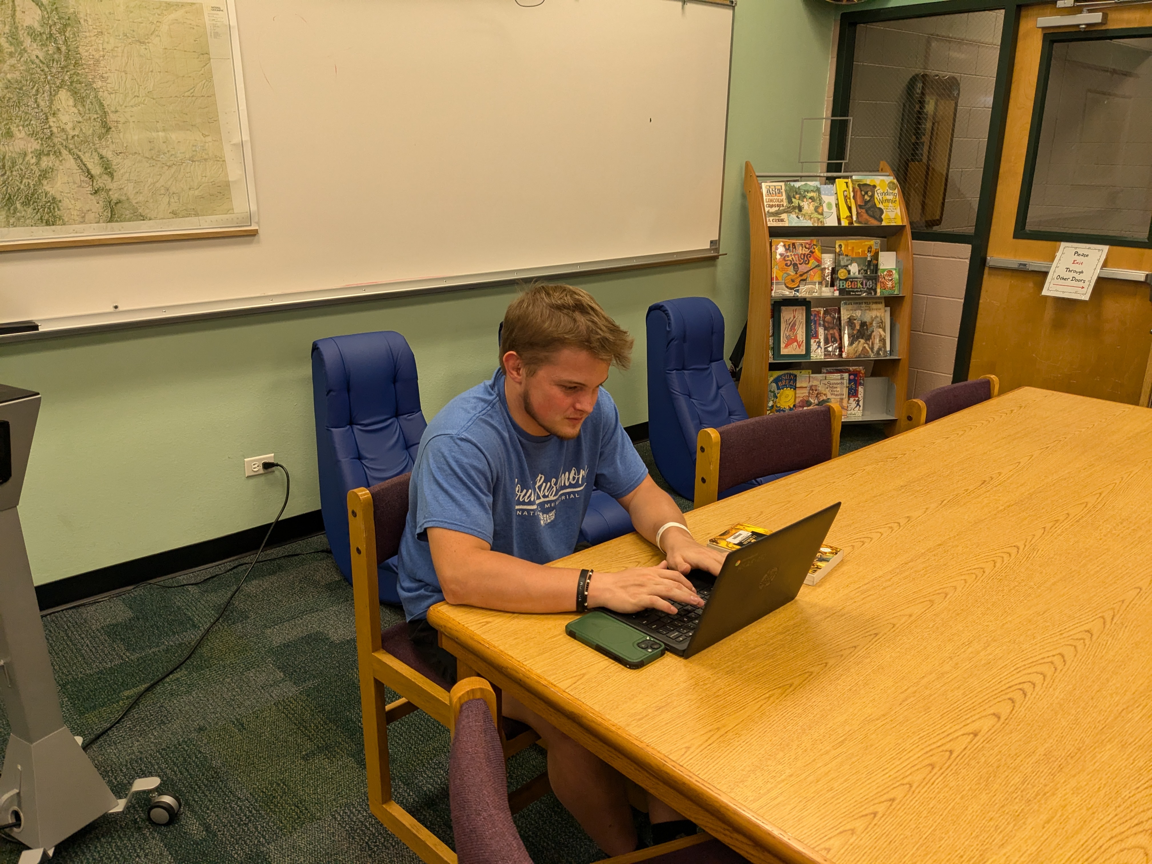 A student working on his computer in the library