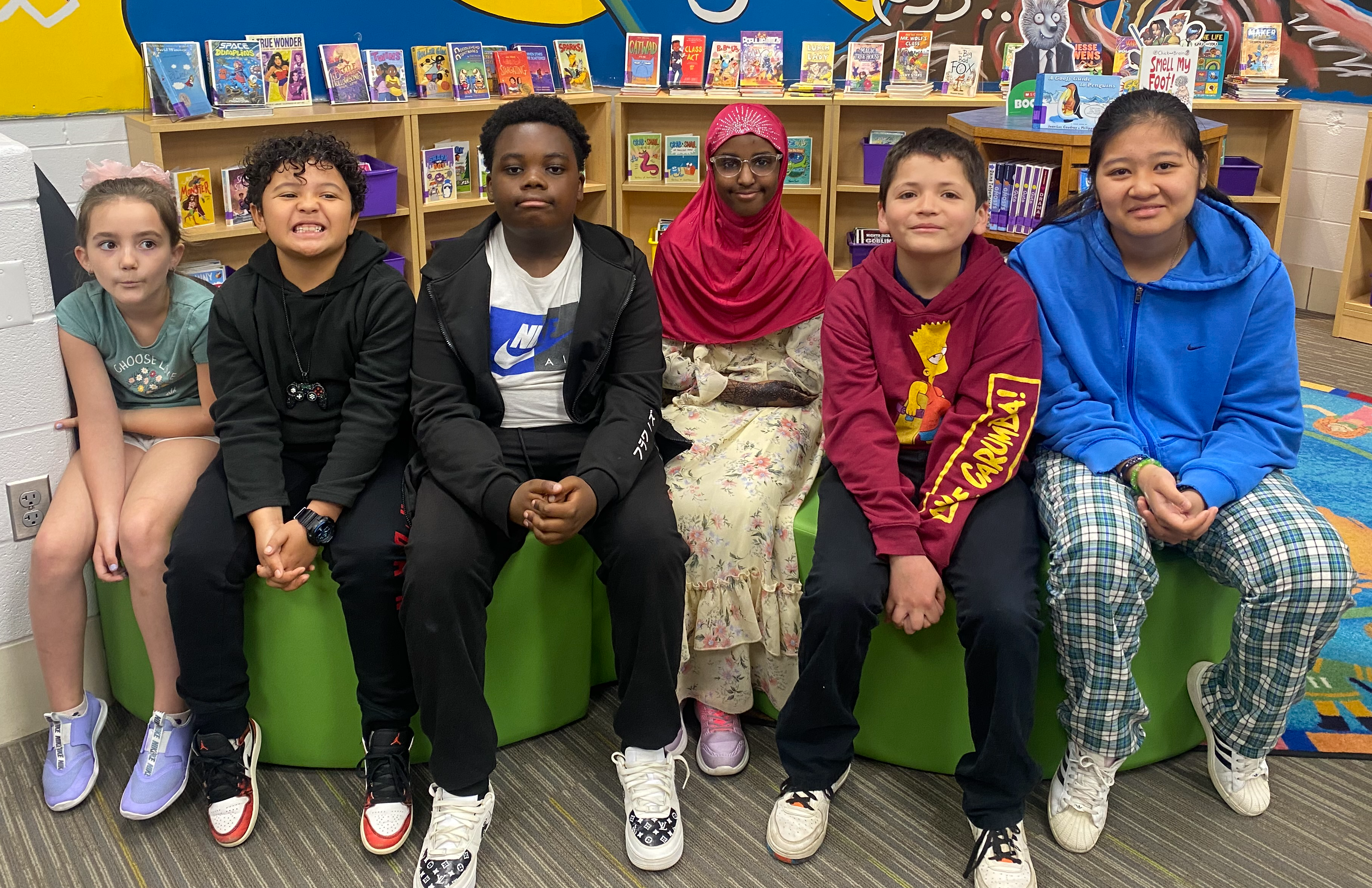 6 students sitting together in a school library