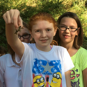 students holding an insect 