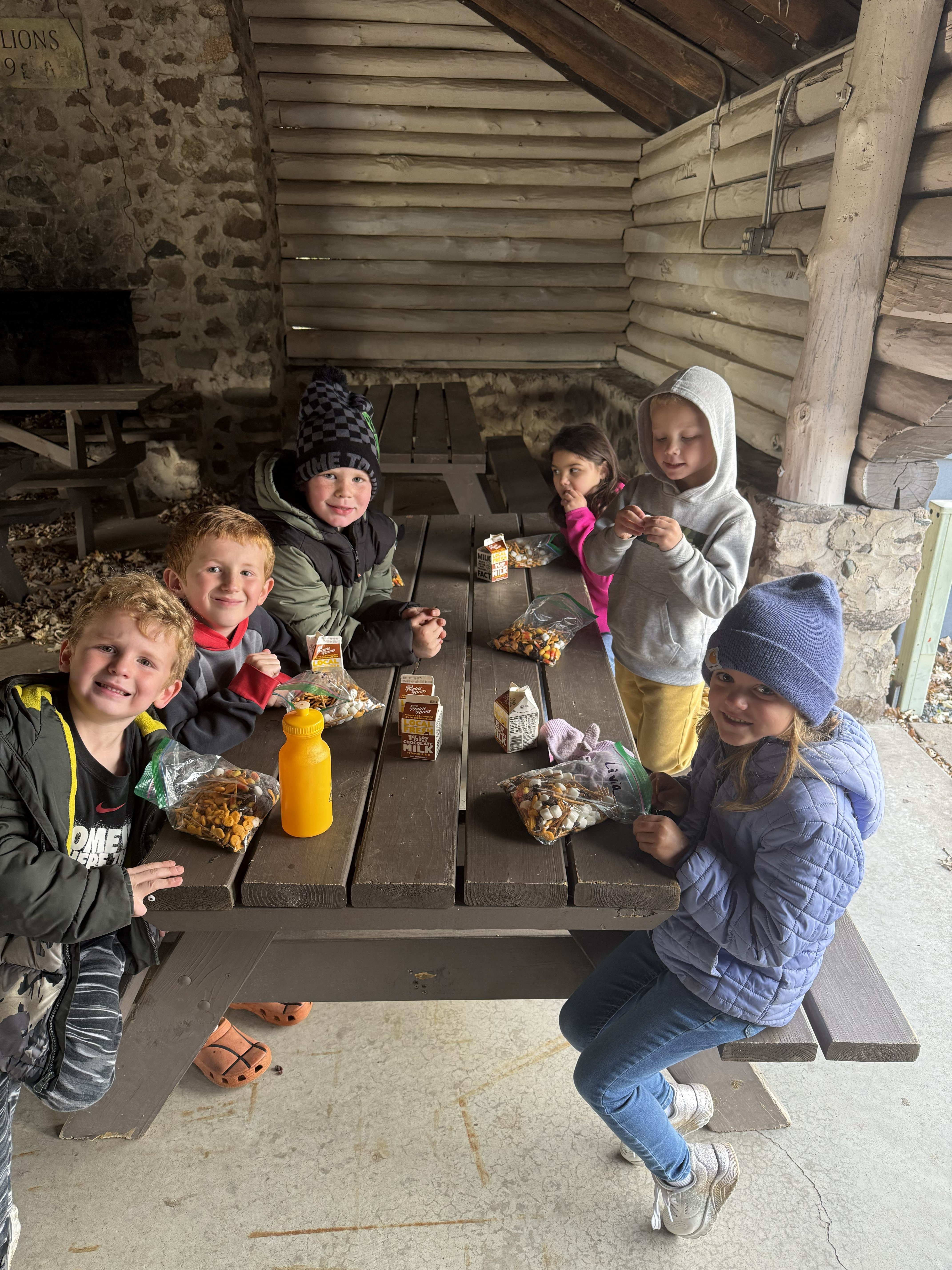 Hornet Care students having a snack at a pavilion.
