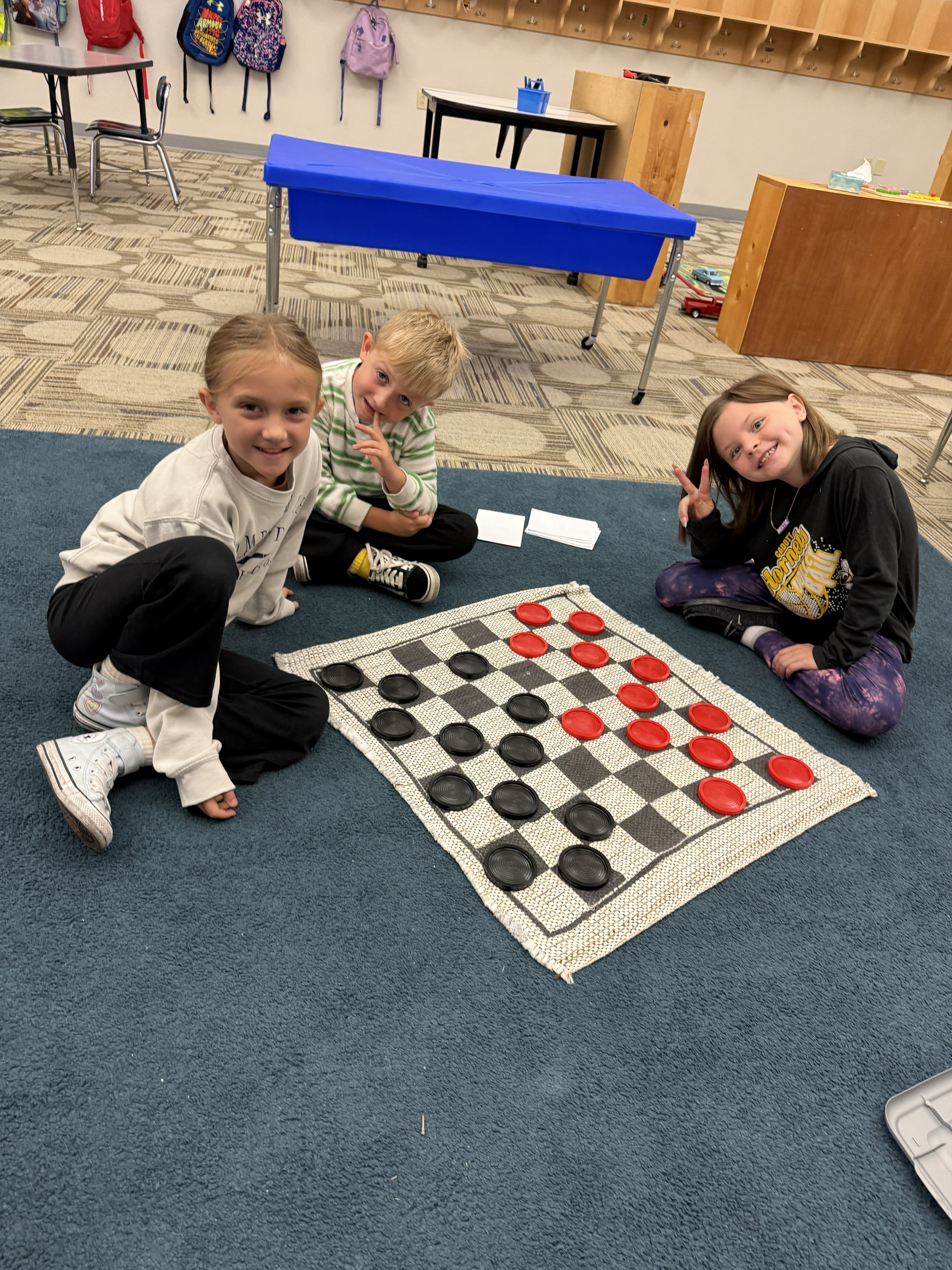 Two Hornet Care students plyaing jumbo checkers.