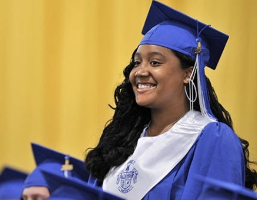 girl wearing graduation outfit and smiling
