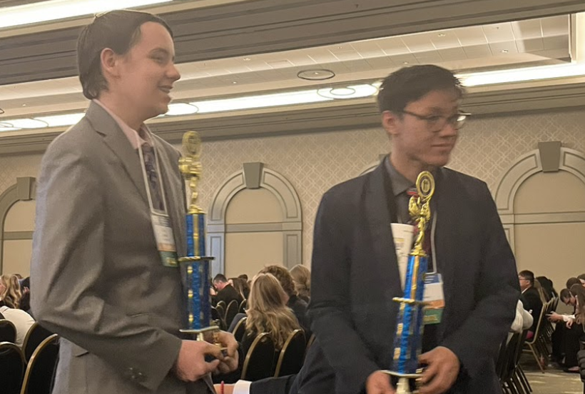 two students getting a trophy