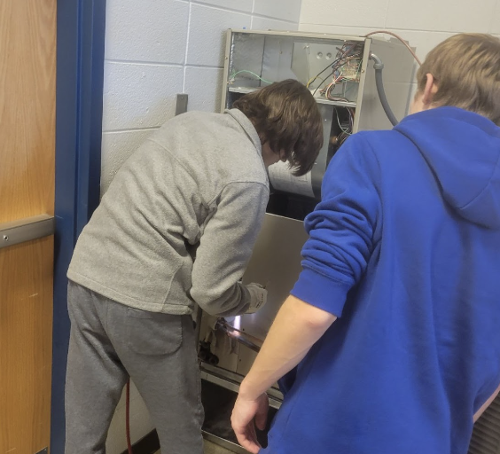 students checking out a machine