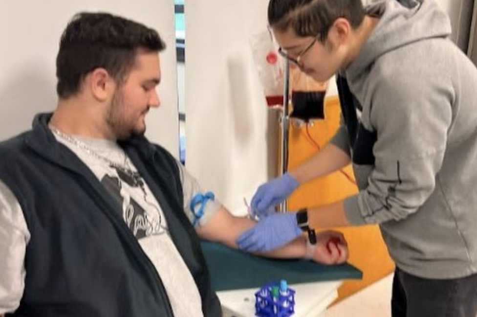 student taking a blood sample