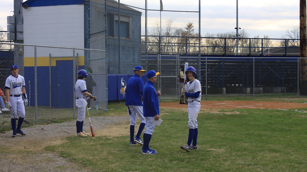 coach talking to the baseball player