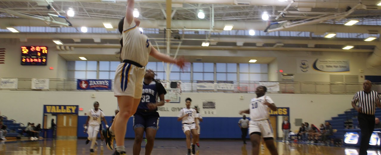 student throwing the ball into the basket