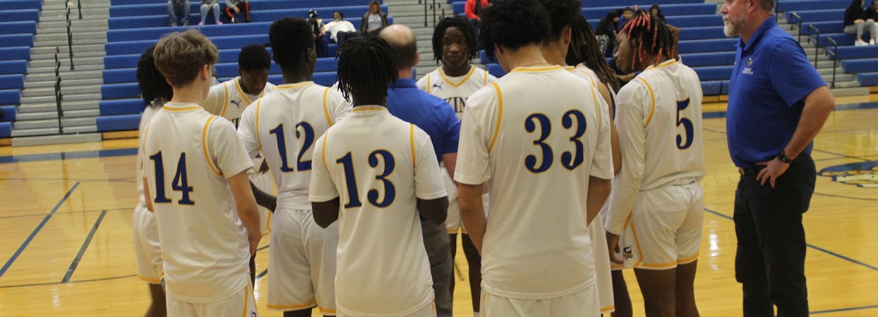 basketball boys gathered together in the court with the coaches