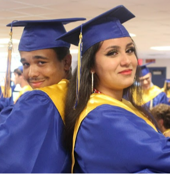 wearing graduation outfit and smiling