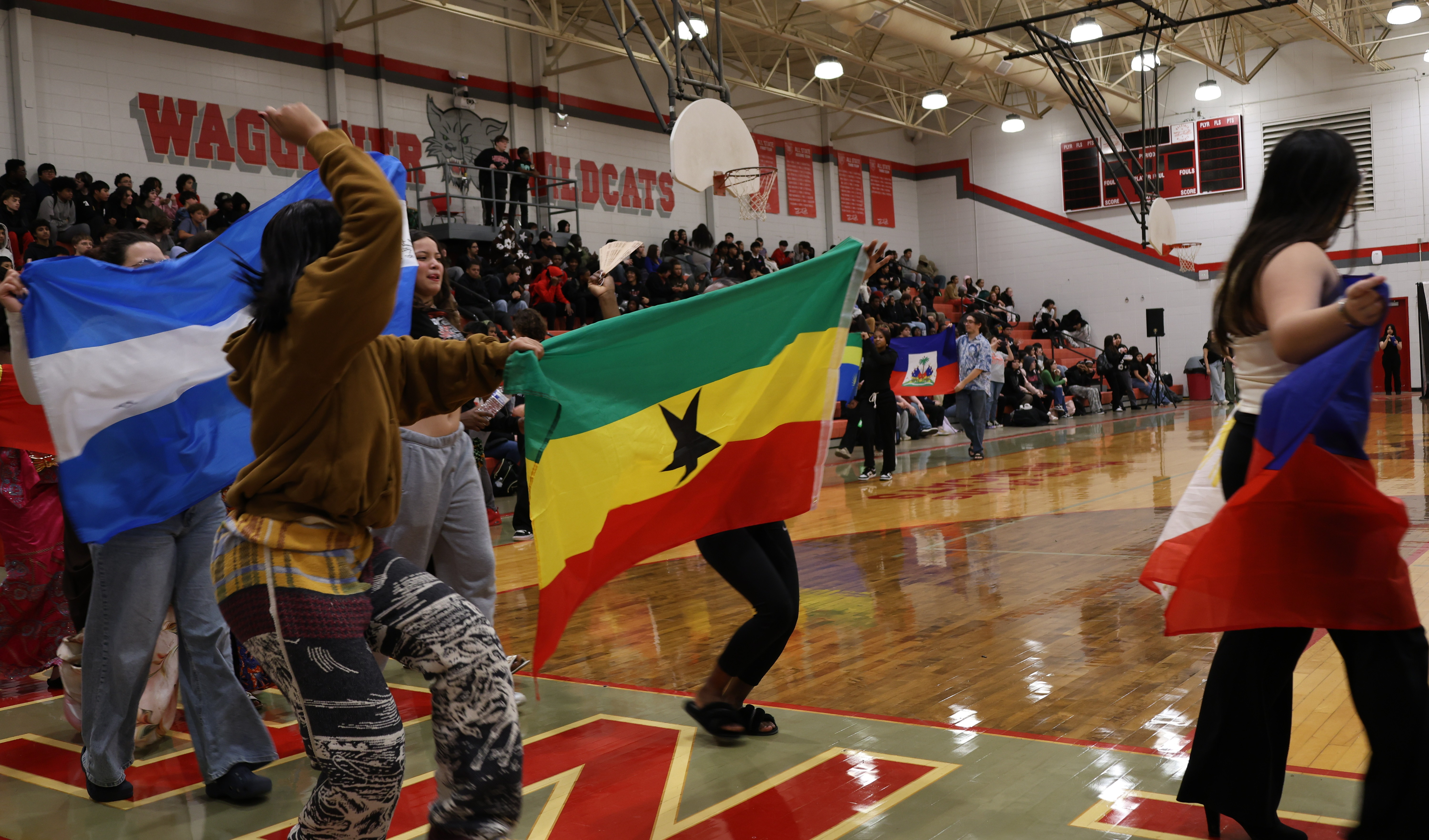 Waggener students carry flags during International Fashion Show