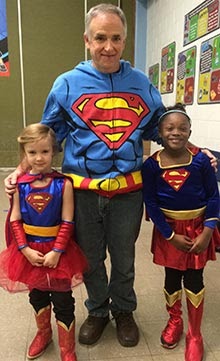 tom with students dressed as supergirls