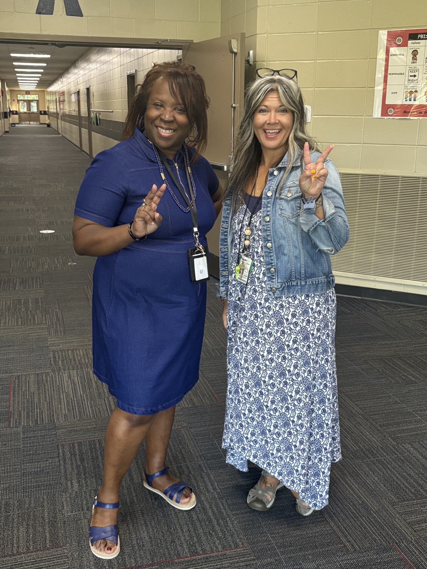 teachers smiling in hallway