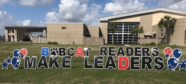 school building from the outside, banner says bobcat readers make leaders