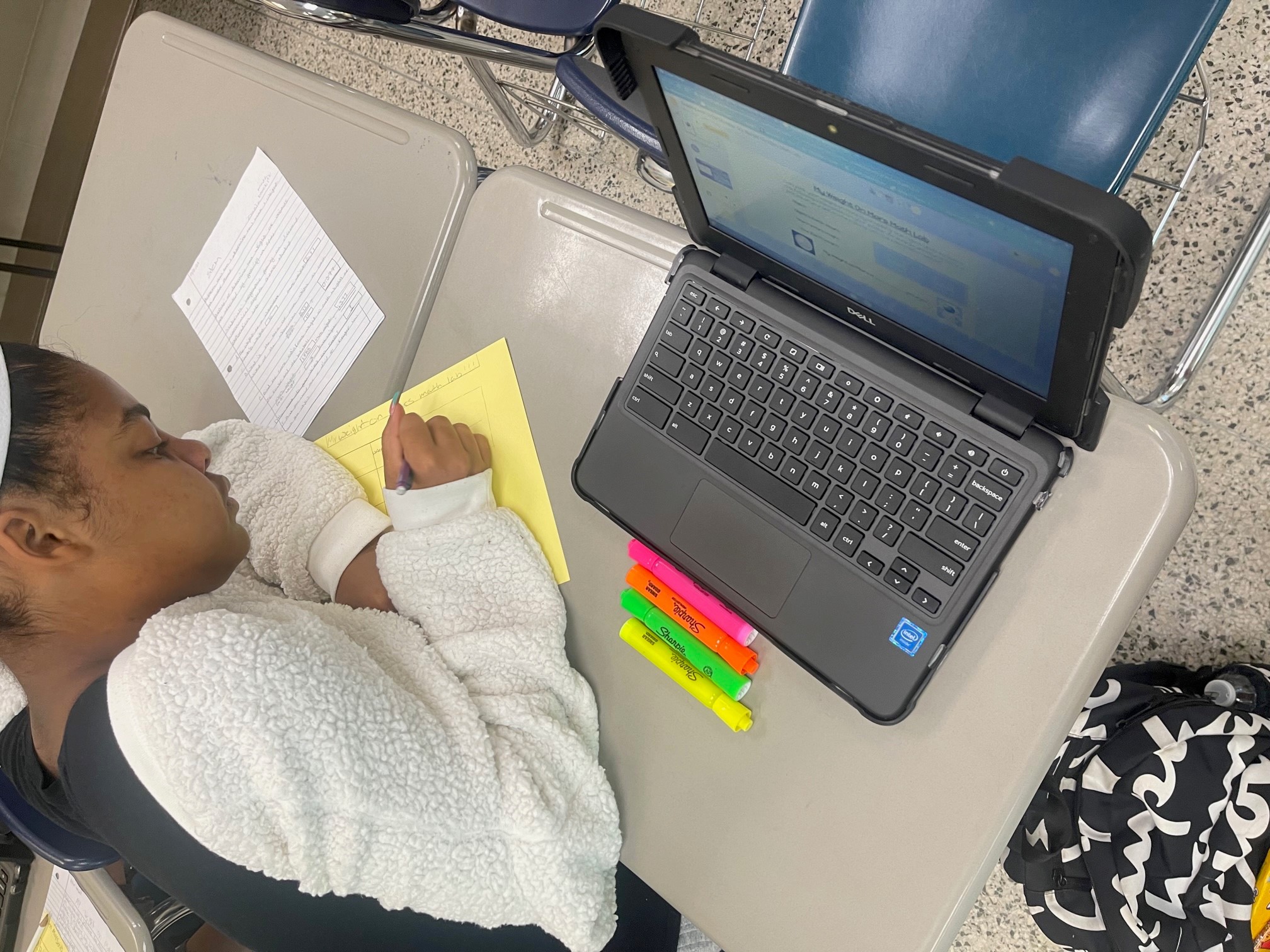 student completing a classroom activity sheet