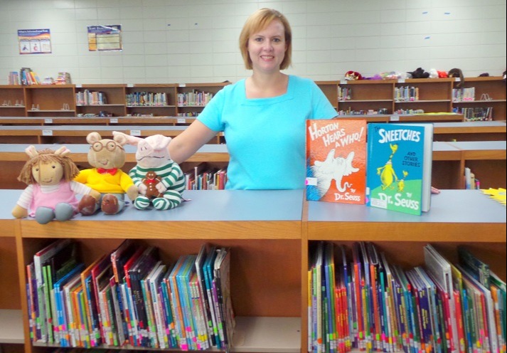 Librarian standing behind a bookshelf 