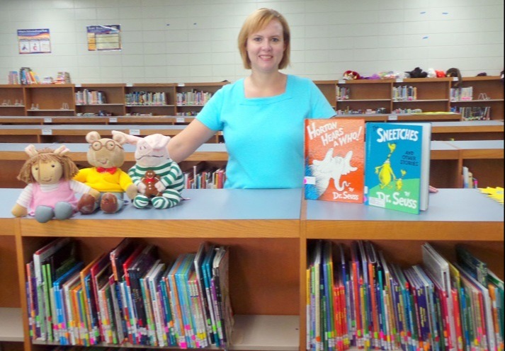 Librarian standing behind a bookshelf