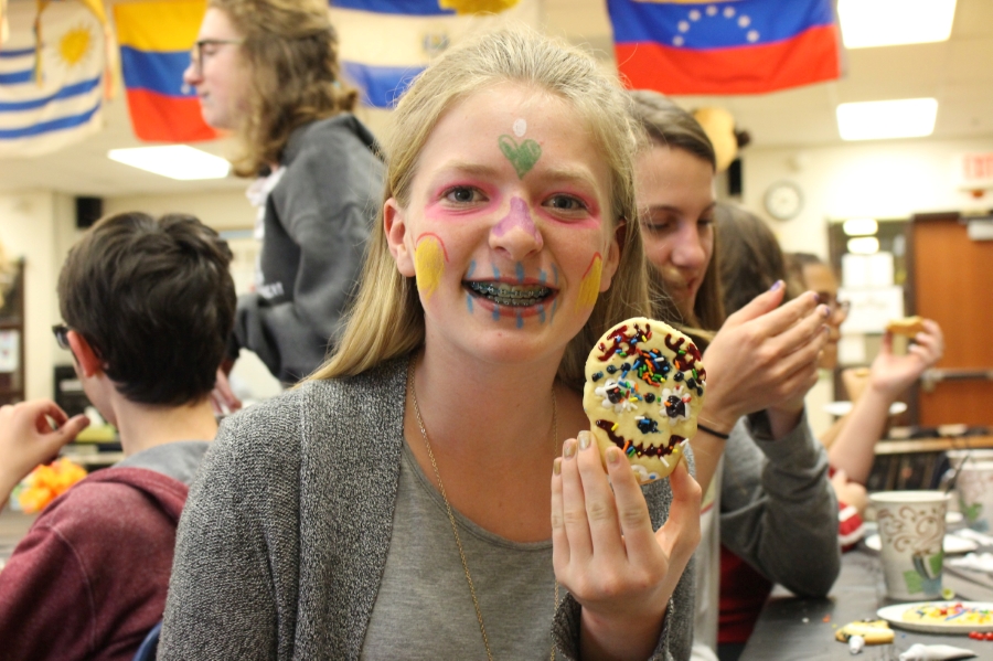 girl holding a. cookie with her hand