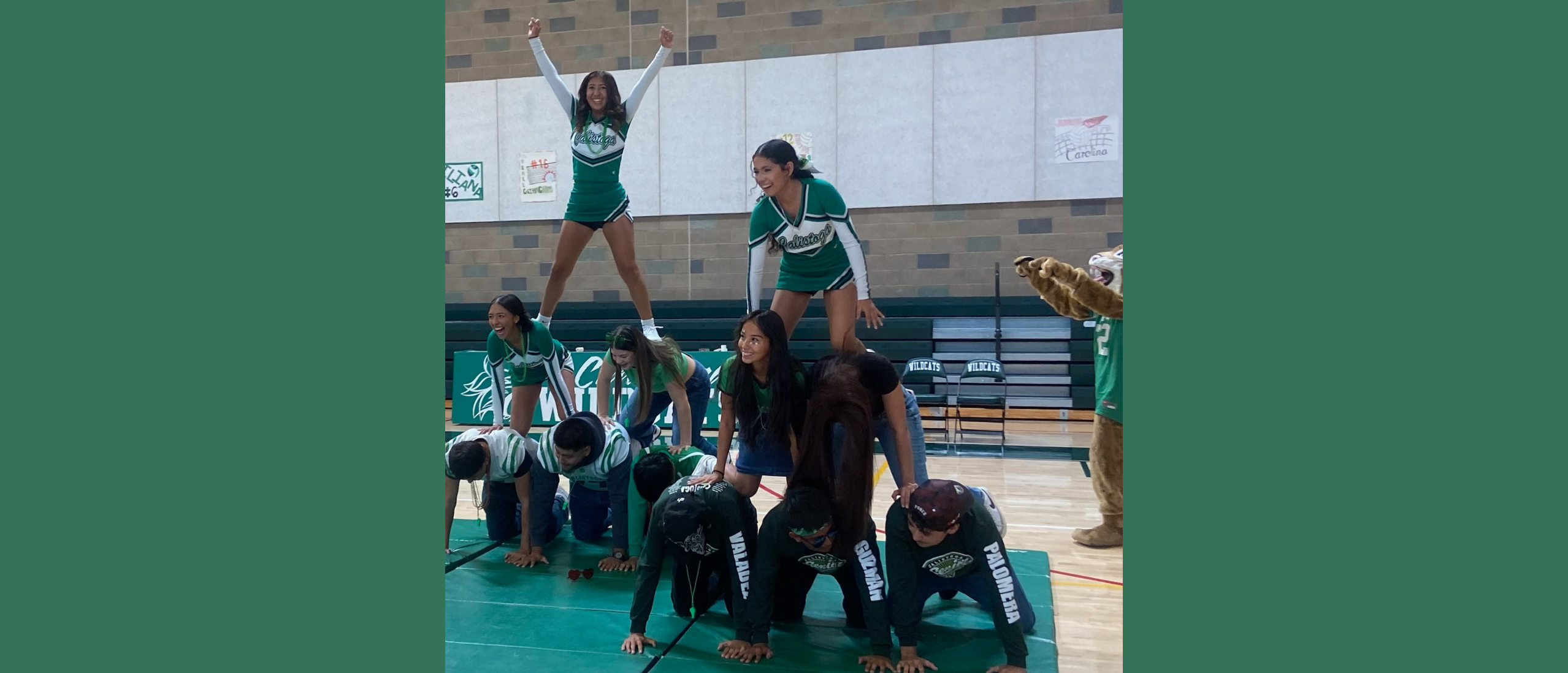 student creating  pyramids during a homecoming rally