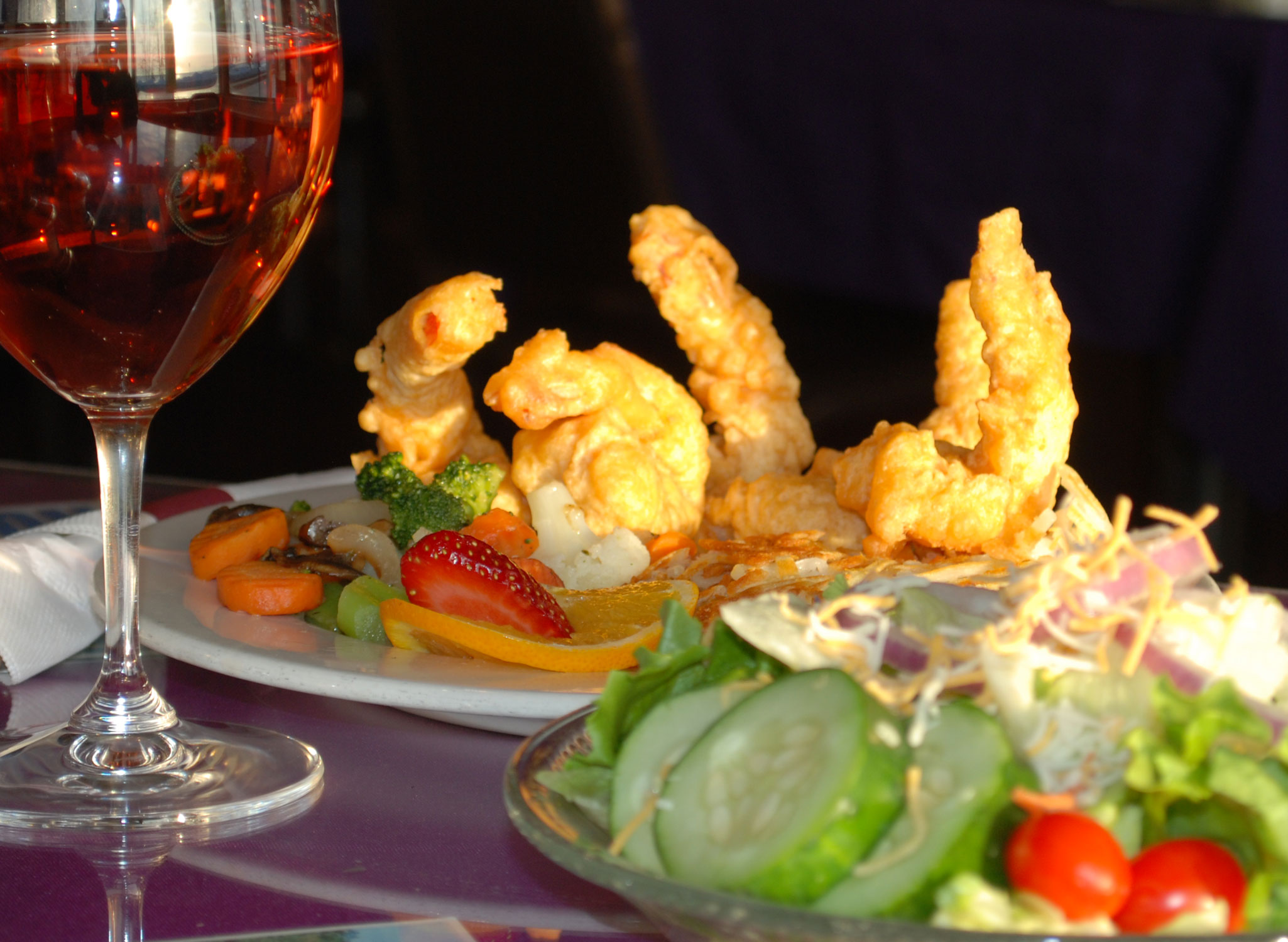 deep fried shrimp with strawberries carrot brocolli dish with rose 