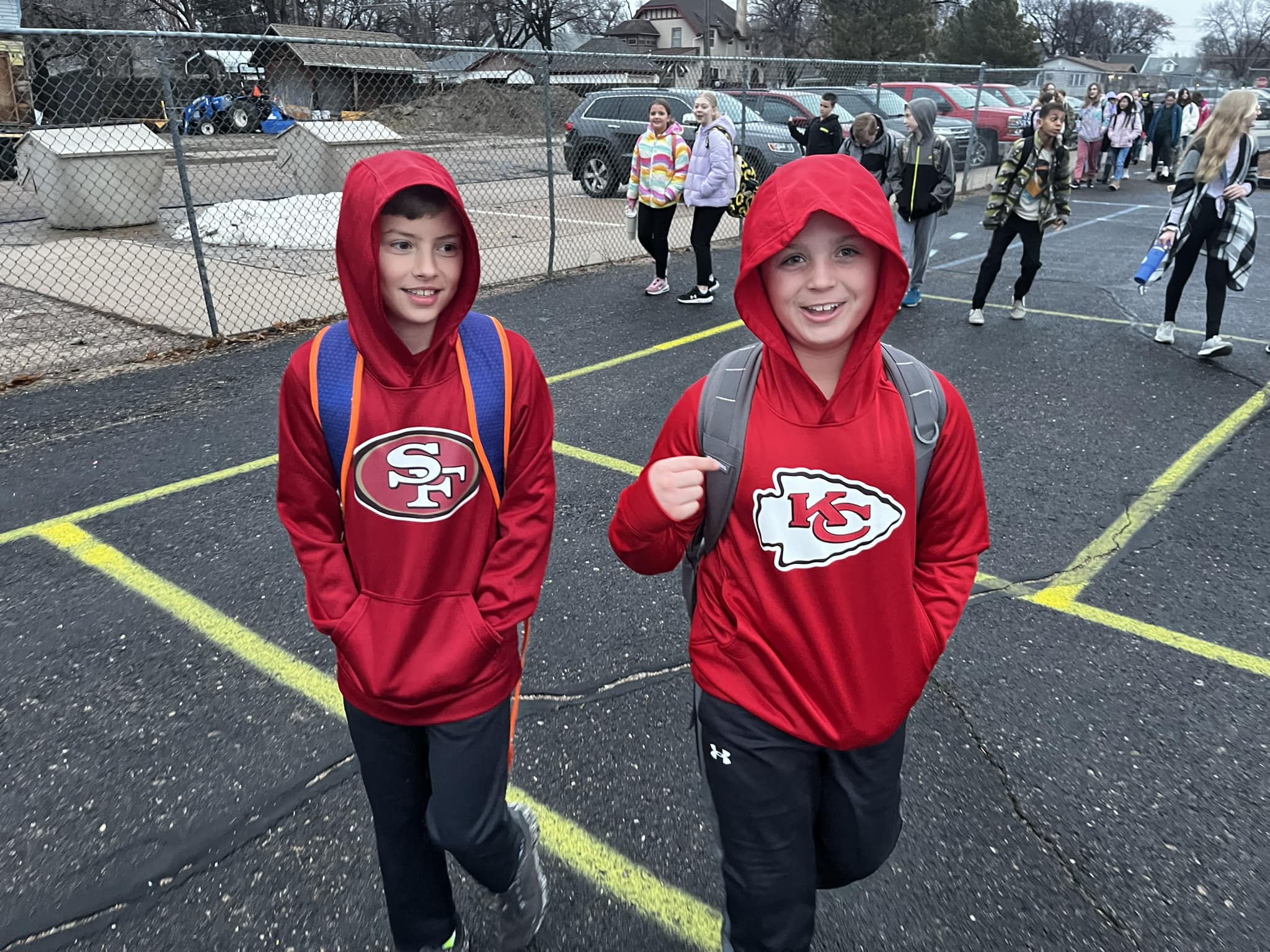 Two students, one in a 49ers hoodie, the other in a Chiefs hoodie. They might disagree but they are still friends.