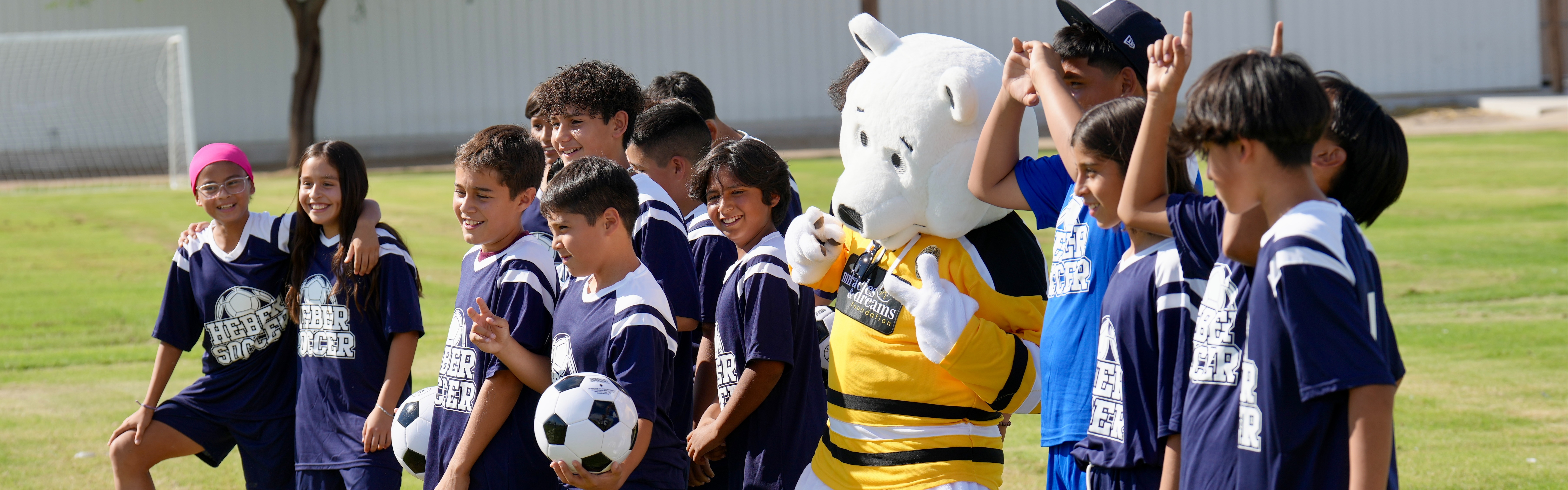 Heber School Soccer Team pictured with the Miracles & Dreams Foundation bear mascot