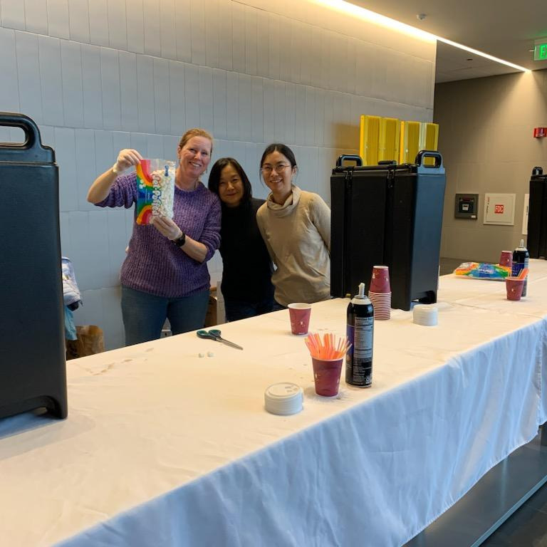 parent volunteers at an event, about to help serve drinks