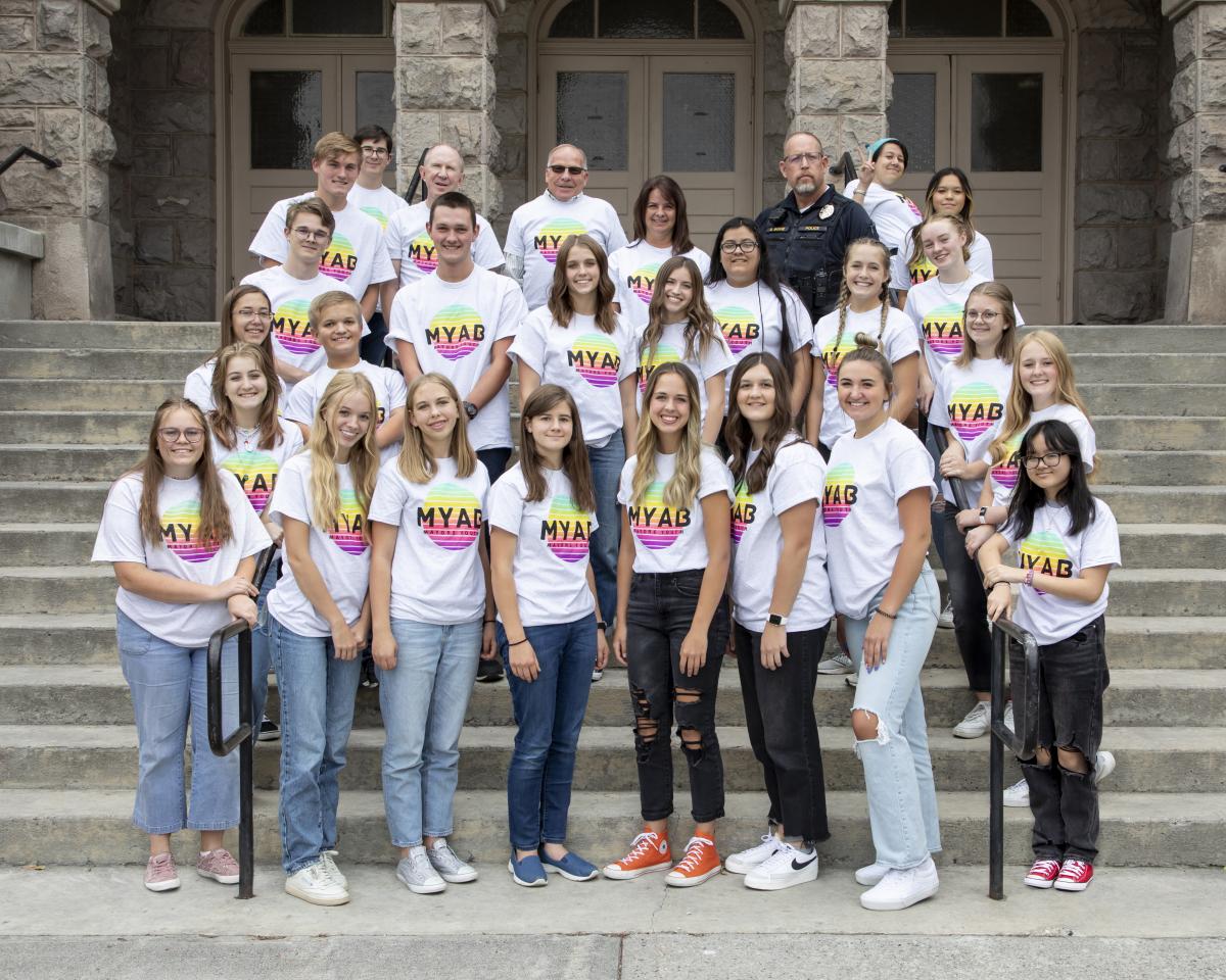 Picture of the mayor's youth advisory board posing on a staircase in front of a building