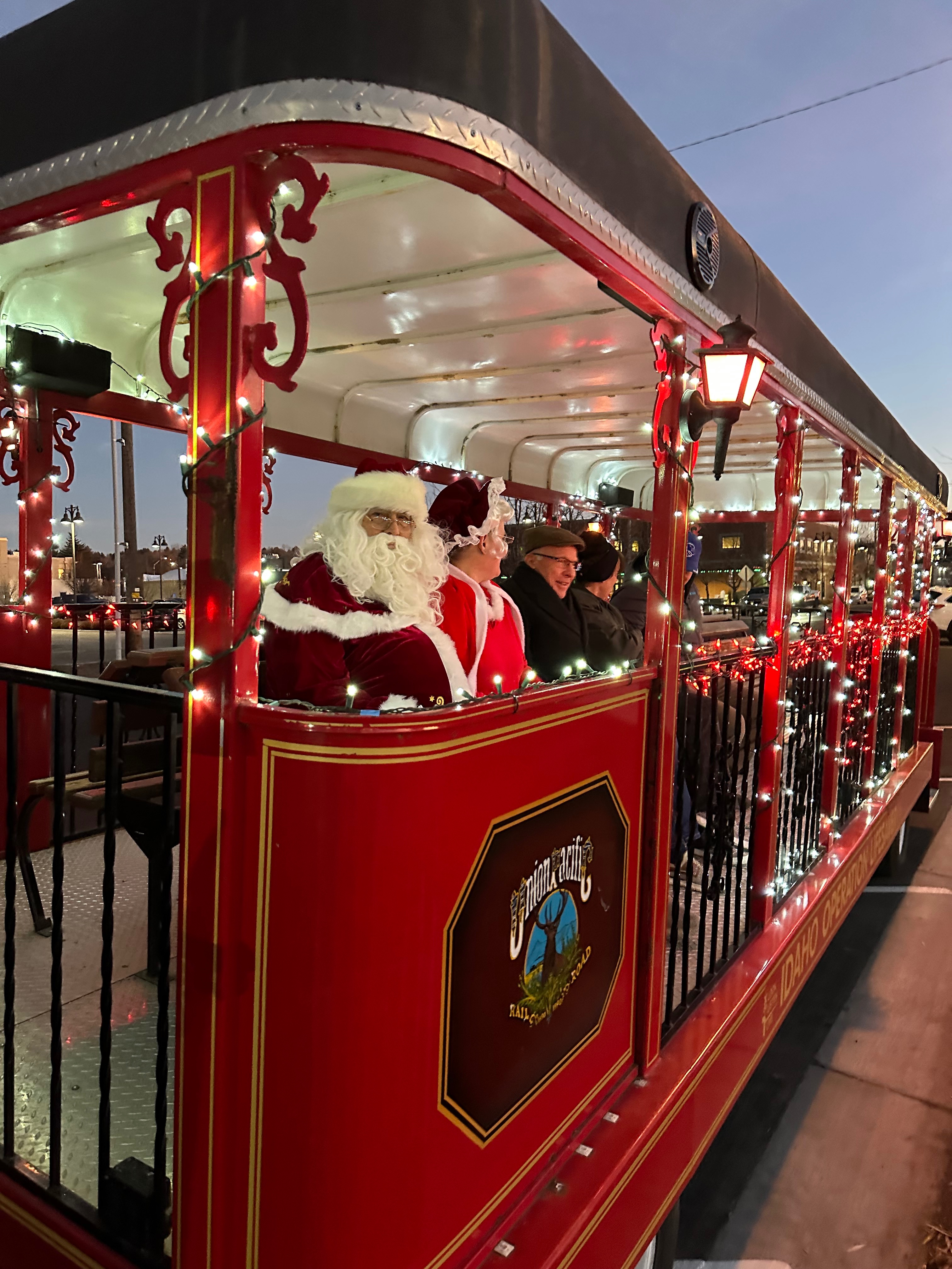 Santa, Mrs. Claus, and the Mayor sit on the Rexburg Holiday Train