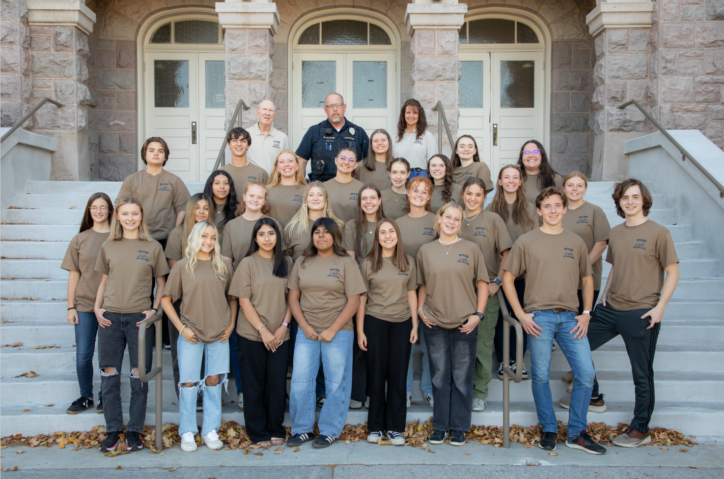 Picture of the mayor's youth advisory board posing on a staircase in front of a building